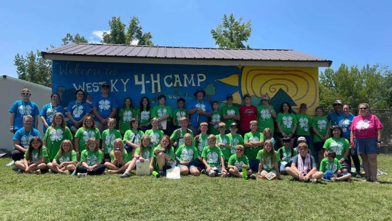 group photo of meade county 4-H camp participants standing in front of WKY 4-H Camp sign